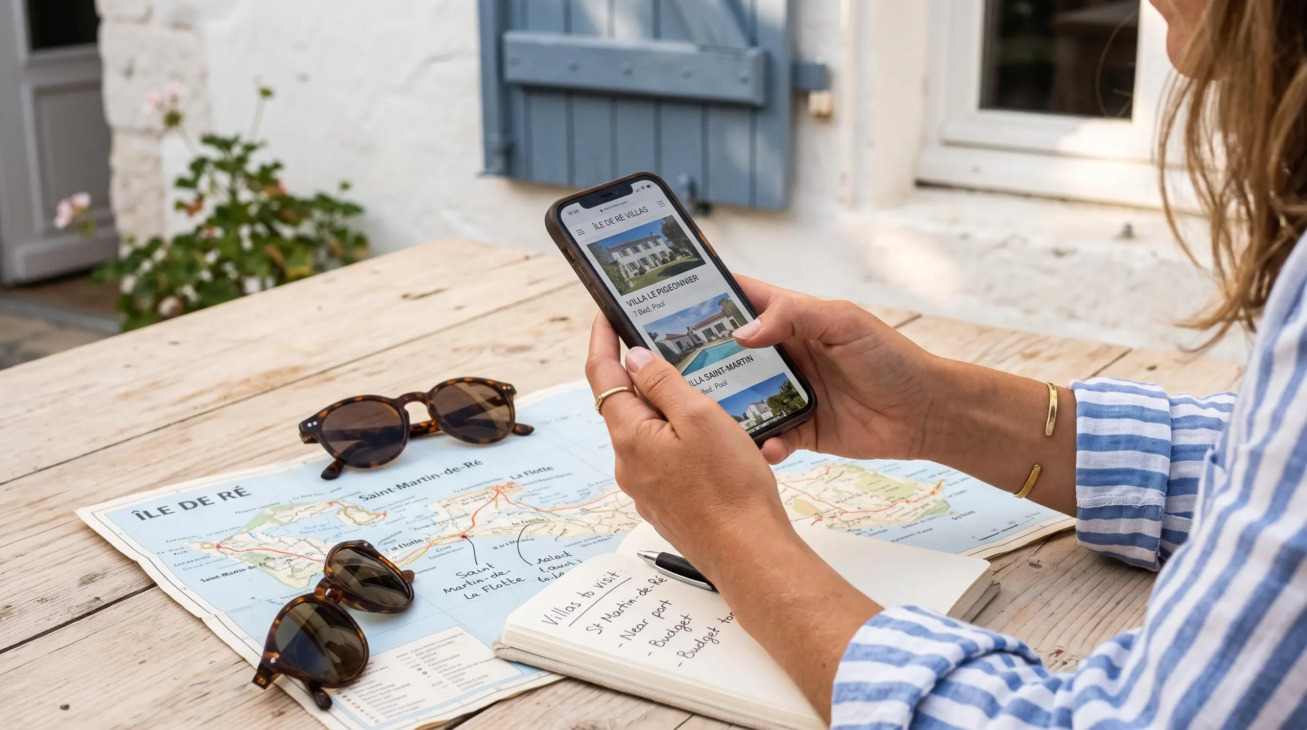 A woman compares villa listings on her phone before booking.